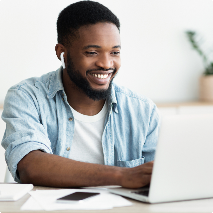 Man-Smiling-On-Computer